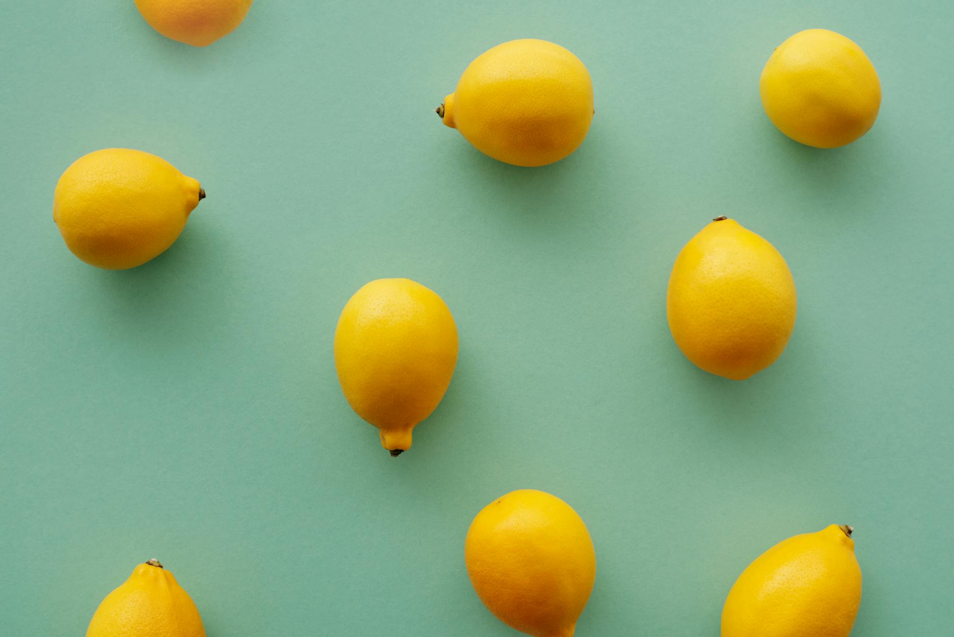 Bright yellow lemons on pastel background symbolizing freshness and new beginnings